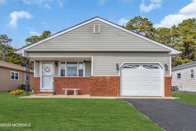 view of front of property with a garage, central AC, brick siding, driveway, and a front yard