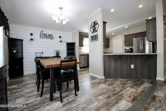 dining space featuring dark wood-type flooring, baseboards, vaulted ceiling, recessed lighting, and a notable chandelier