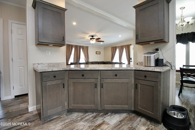 kitchen with a peninsula, baseboards, and ornamental molding