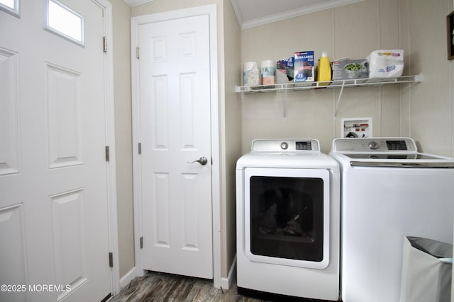 clothes washing area with dark wood finished floors, laundry area, independent washer and dryer, and ornamental molding