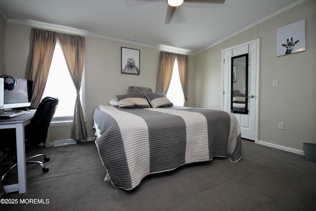 carpeted bedroom featuring baseboards, crown molding, and ceiling fan