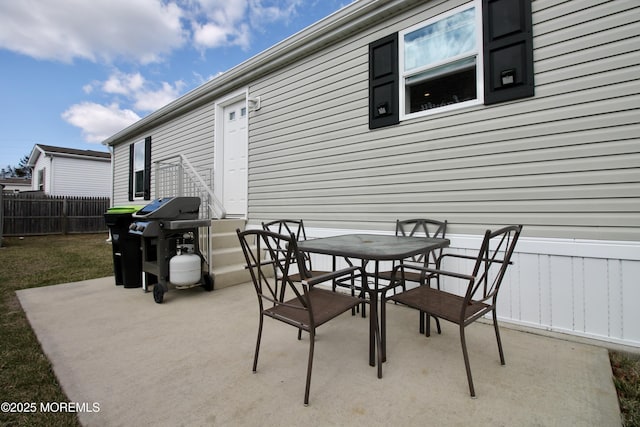 view of patio / terrace with outdoor dining area, fence, and grilling area