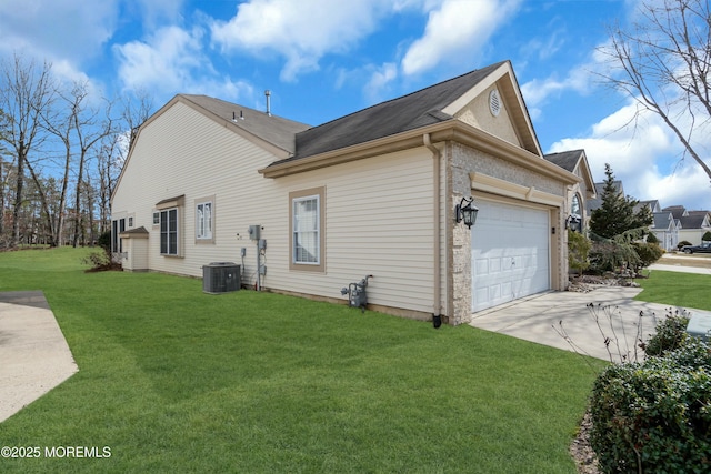 view of home's exterior featuring cooling unit, driveway, a lawn, and an attached garage