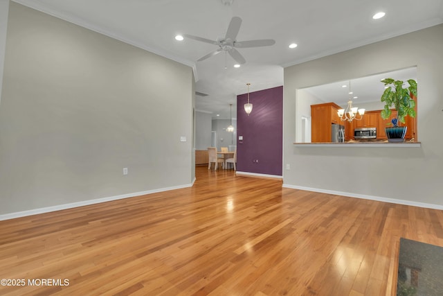 unfurnished living room with baseboards, ornamental molding, recessed lighting, light wood-style flooring, and ceiling fan with notable chandelier