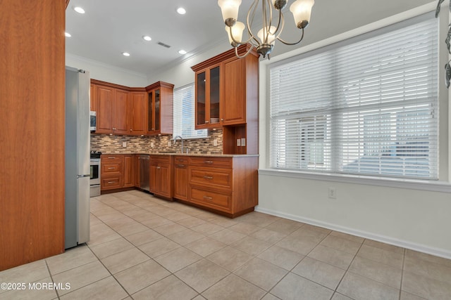 kitchen with crown molding, light countertops, decorative backsplash, appliances with stainless steel finishes, and brown cabinetry