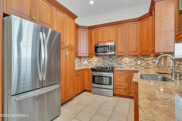 kitchen with light tile patterned floors, a sink, decorative backsplash, stainless steel appliances, and crown molding