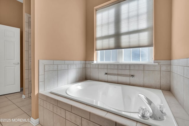 bathroom with tile patterned flooring and a garden tub