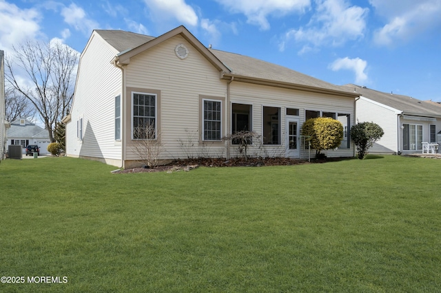 view of side of property with central air condition unit and a yard