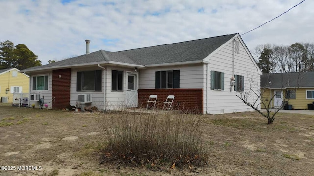 view of front of home featuring a shingled roof and brick siding