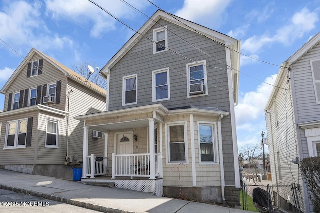 view of front of house with covered porch and fence