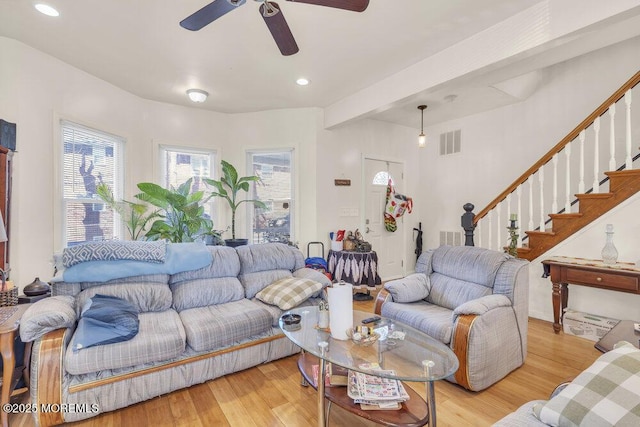 living area featuring stairway, visible vents, light wood finished floors, and recessed lighting