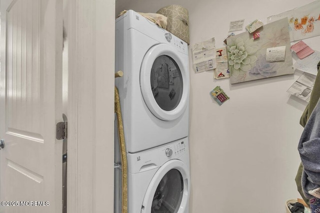 clothes washing area with laundry area and stacked washer / drying machine