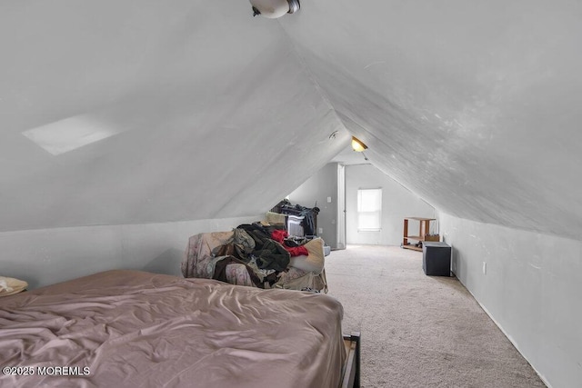 carpeted bedroom with lofted ceiling