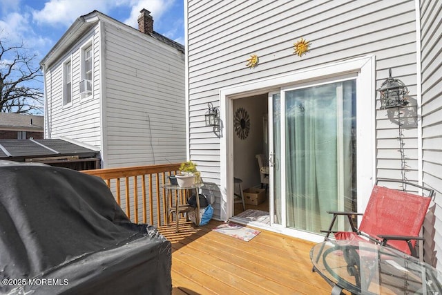 wooden deck with a grill