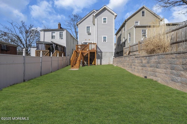 view of yard featuring a fenced backyard and stairway