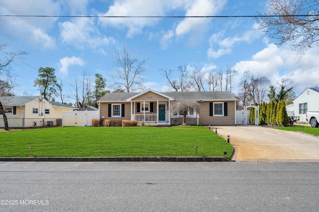 view of front of property featuring driveway, a gate, a porch, fence, and a front yard