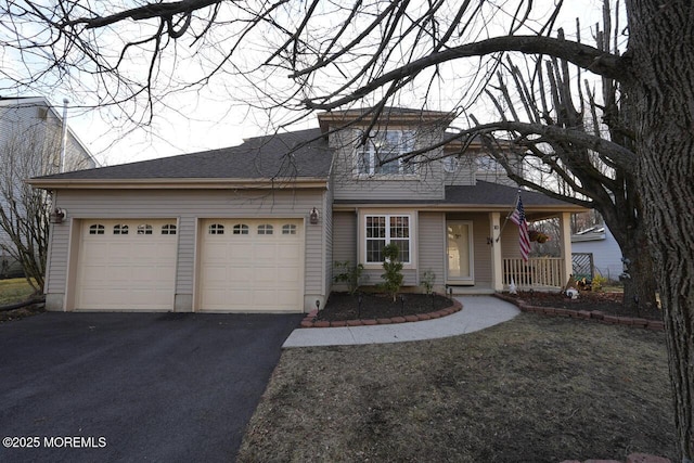 view of front facade featuring driveway, an attached garage, a porch, and roof with shingles