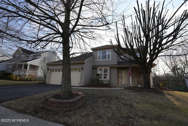 view of front of house with aphalt driveway and an attached garage