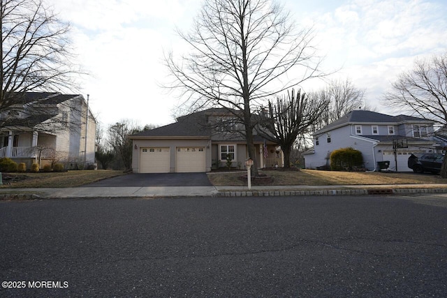 view of front of property with a garage and aphalt driveway