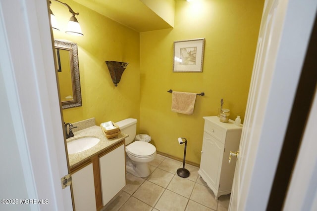 bathroom with vanity, tile patterned flooring, and toilet