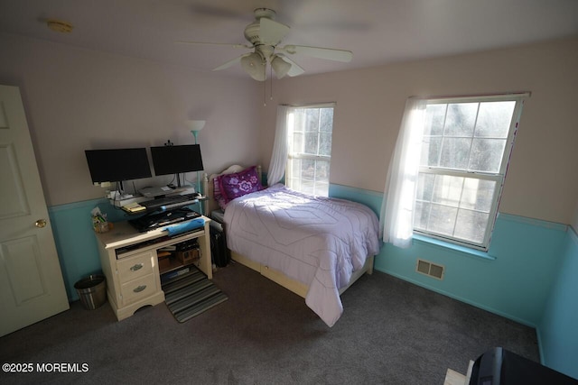 carpeted bedroom featuring visible vents and ceiling fan