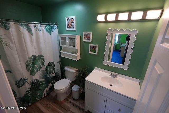 full bathroom with vanity, a shower with shower curtain, wood finished floors, and toilet