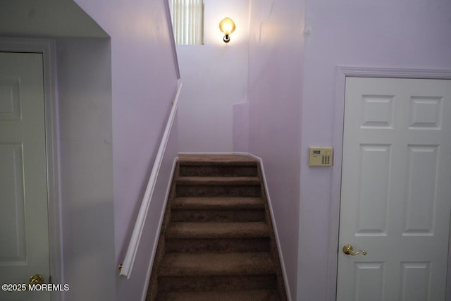 staircase featuring baseboards