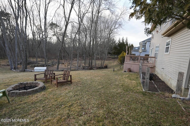 view of yard featuring a fire pit and a deck