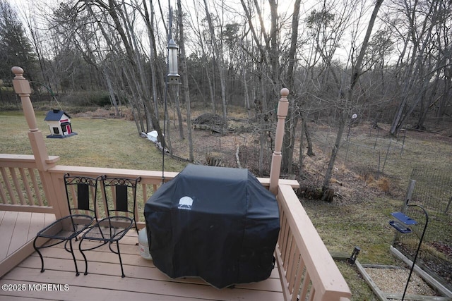 wooden deck featuring a yard and grilling area