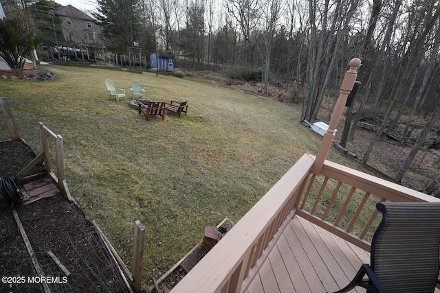 view of yard with a fire pit and a deck