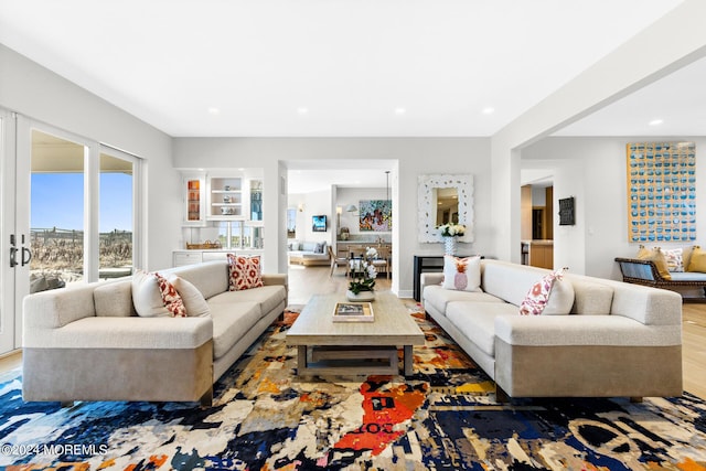 living area featuring wood finished floors and recessed lighting