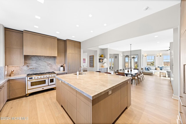 kitchen featuring double oven range, modern cabinets, and light countertops