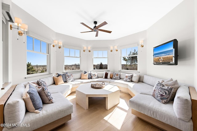 living area featuring wood finished floors and a ceiling fan