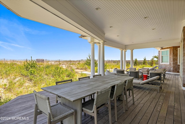 wooden deck featuring outdoor dining area