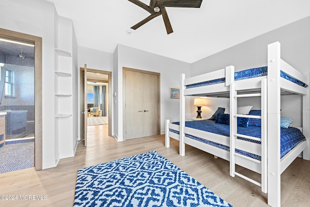 bedroom with ceiling fan, wood finished floors, and baseboards