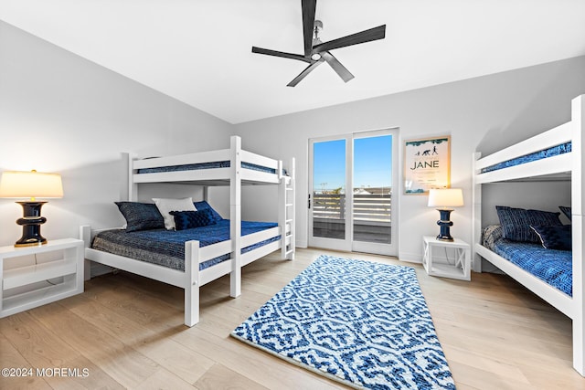 bedroom featuring a ceiling fan, access to outside, and wood finished floors