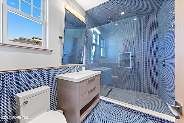 full bathroom with toilet, a wainscoted wall, vanity, visible vents, and walk in shower