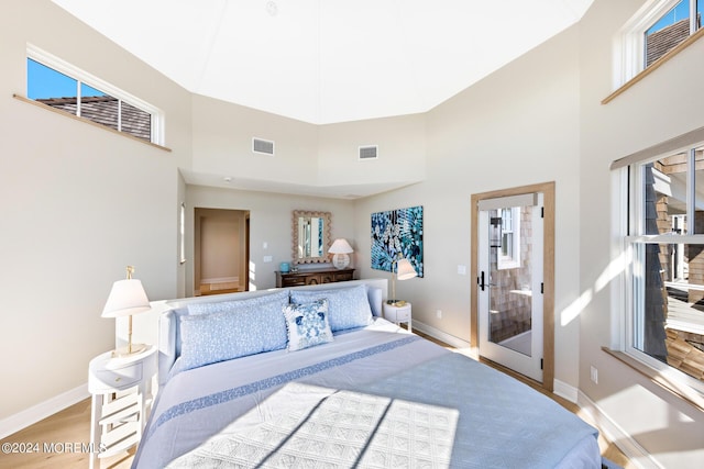 bedroom featuring wood finished floors, visible vents, and baseboards