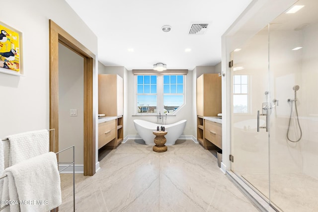 full bath featuring visible vents, a freestanding bath, a shower stall, and vanity