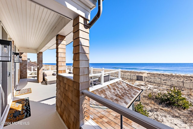 balcony with a water view and a beach view