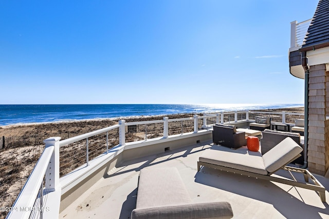 view of patio / terrace featuring a view of the beach and a water view