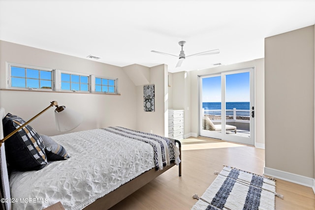 bedroom featuring baseboards, access to outside, visible vents, and wood finished floors