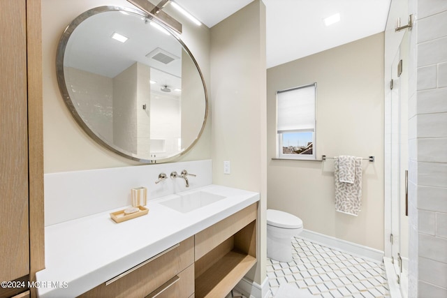 bathroom featuring toilet, baseboards, visible vents, and vanity