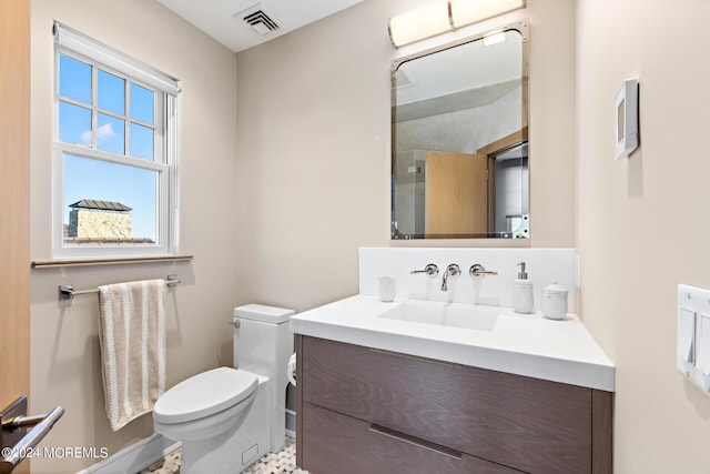 bathroom with toilet, an enclosed shower, visible vents, and vanity