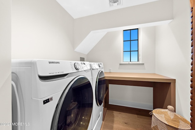 laundry area featuring laundry area, visible vents, independent washer and dryer, and wood finished floors