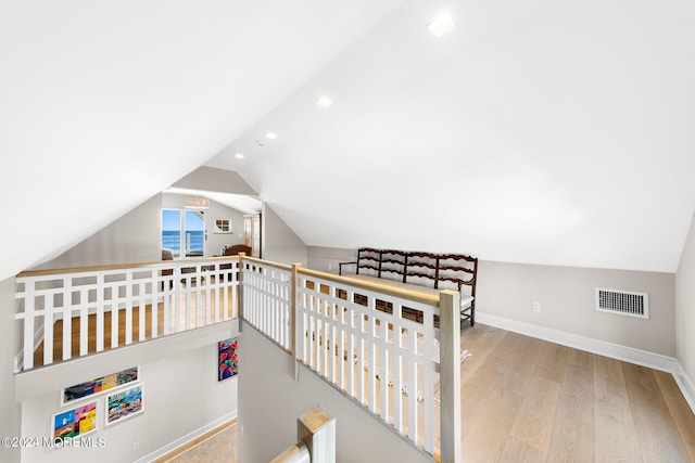 bedroom featuring baseboards, visible vents, lofted ceiling, hardwood / wood-style floors, and recessed lighting