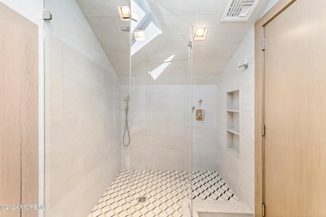 full bath featuring a stall shower, visible vents, and lofted ceiling