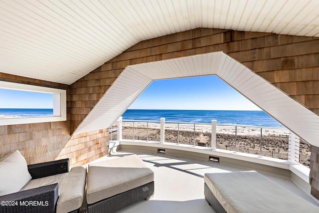 view of patio with a water view and a view of the beach