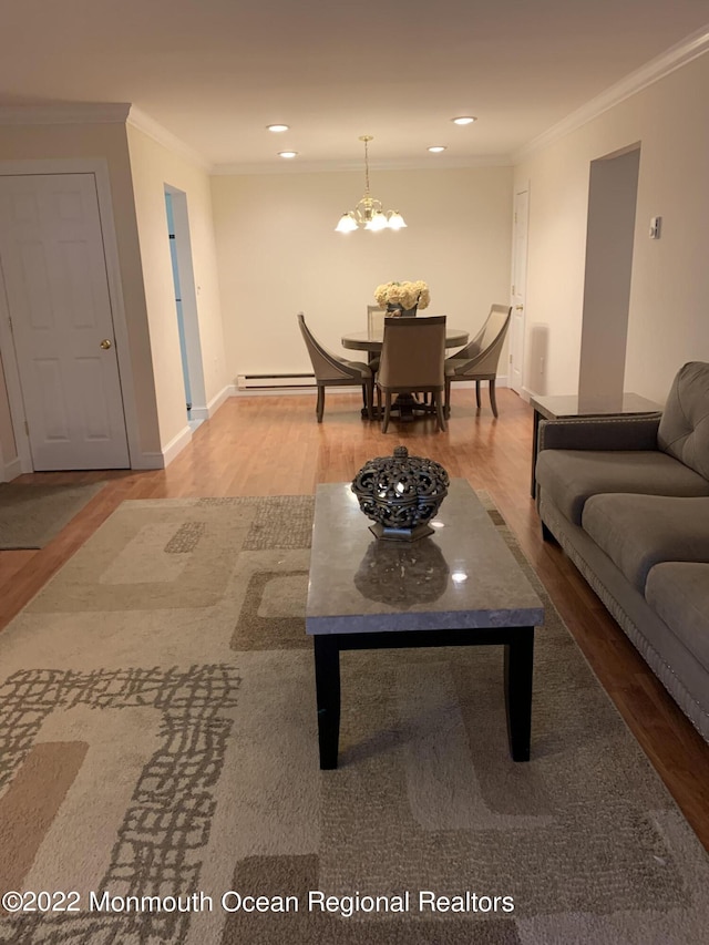 living room featuring a baseboard radiator, ornamental molding, wood finished floors, and recessed lighting