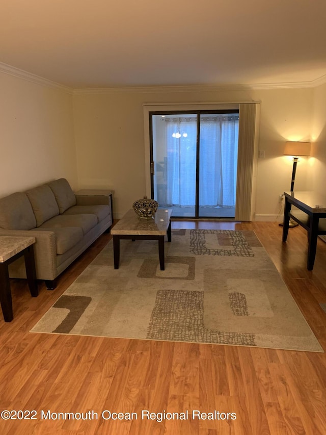 living room with ornamental molding and wood finished floors